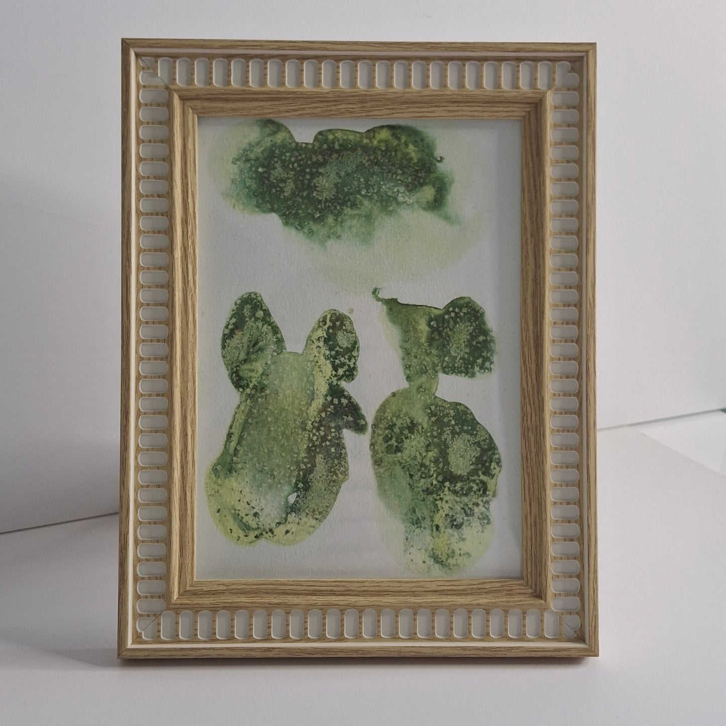 Single green artwork with multiple organic shapes and soft leafy textures