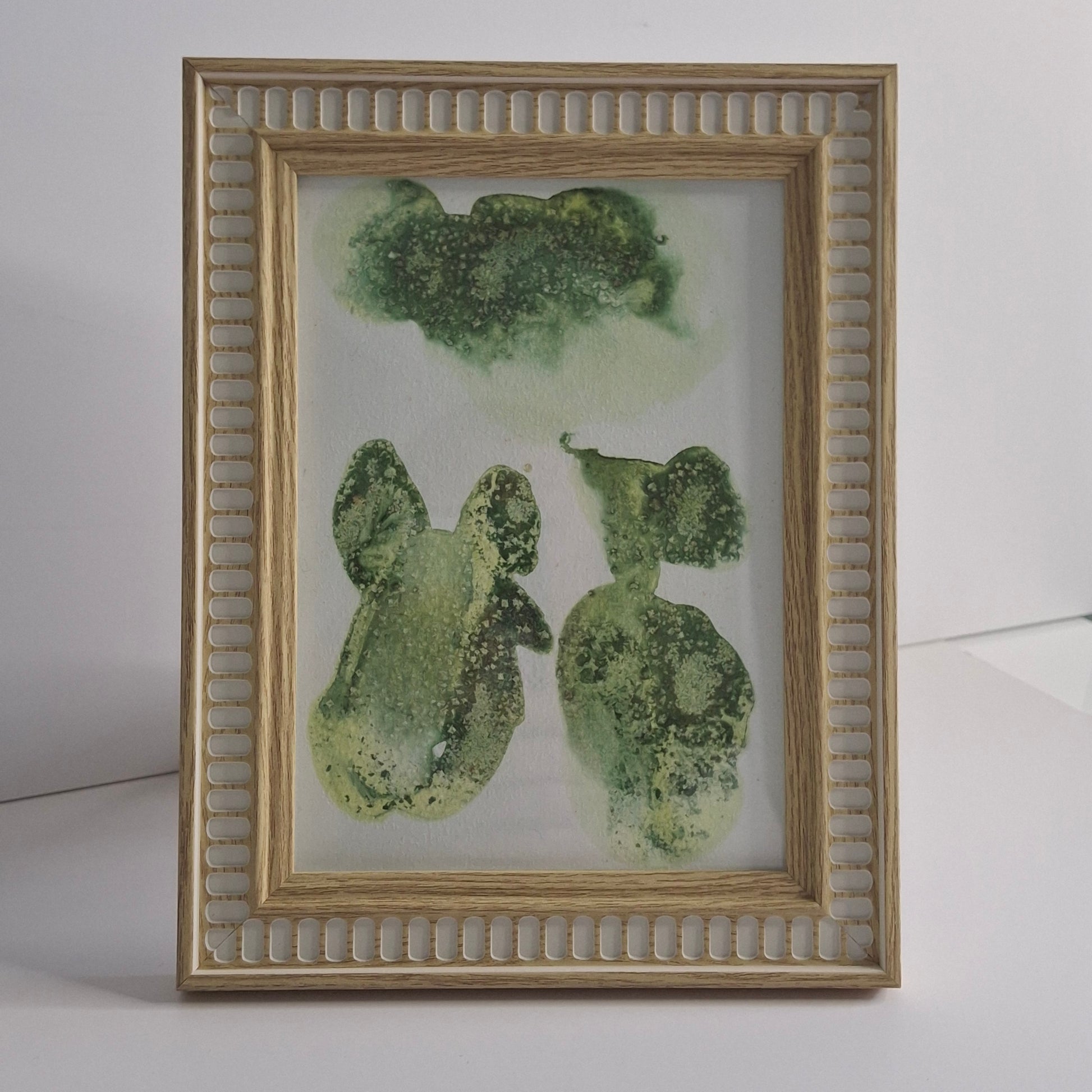 Single green artwork with multiple organic shapes and soft leafy textures
