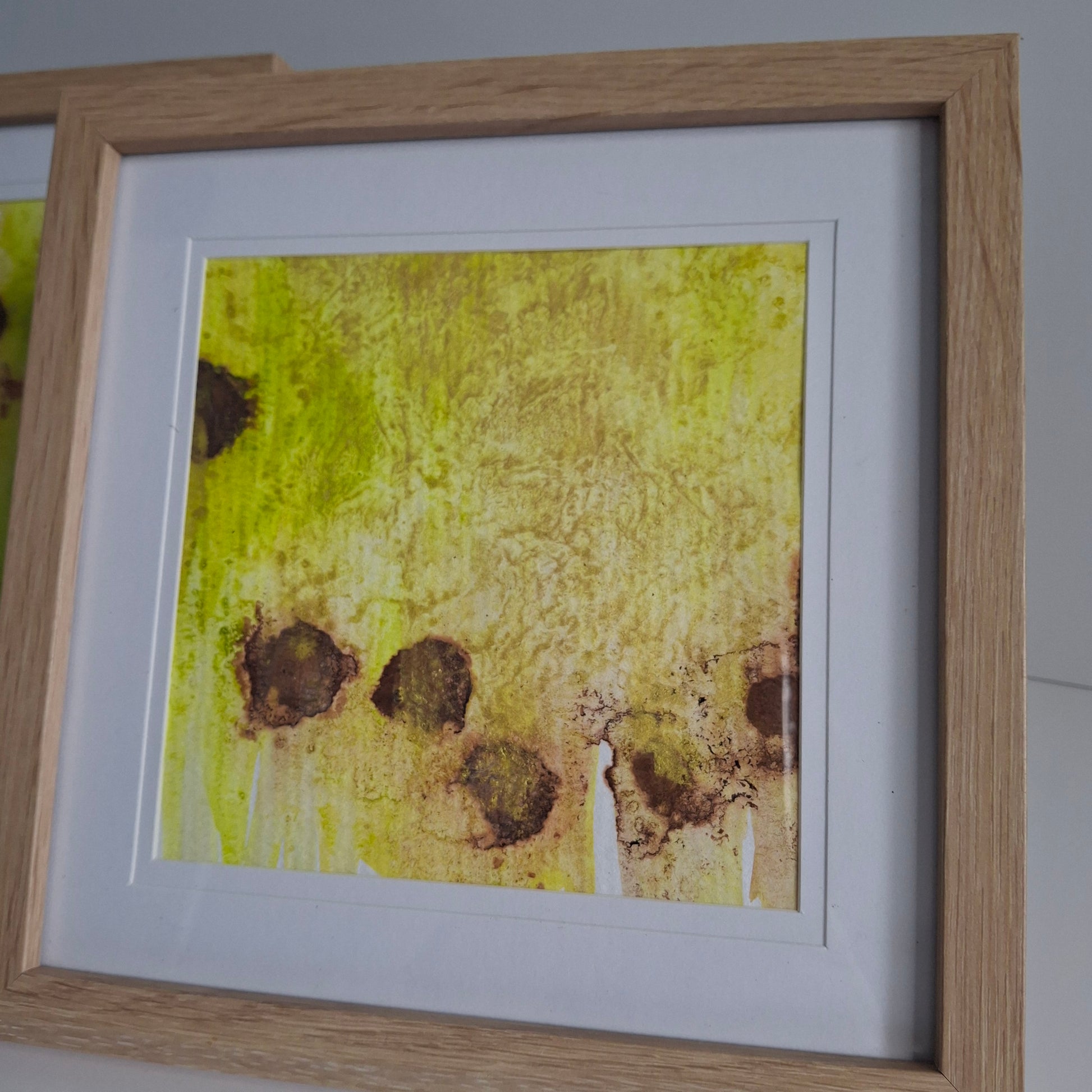 Single artwork with golden yellow wash and clustered brown forms in the lower half.