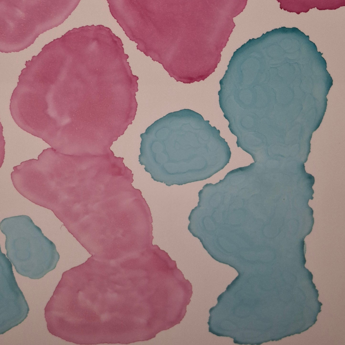 Framed abstract alcohol ink painting titled Currents of Love by Elizabeth Marshall, featuring organic flowing shapes in soft blue and vibrant pink, evoking coral reefs and ocean currents.