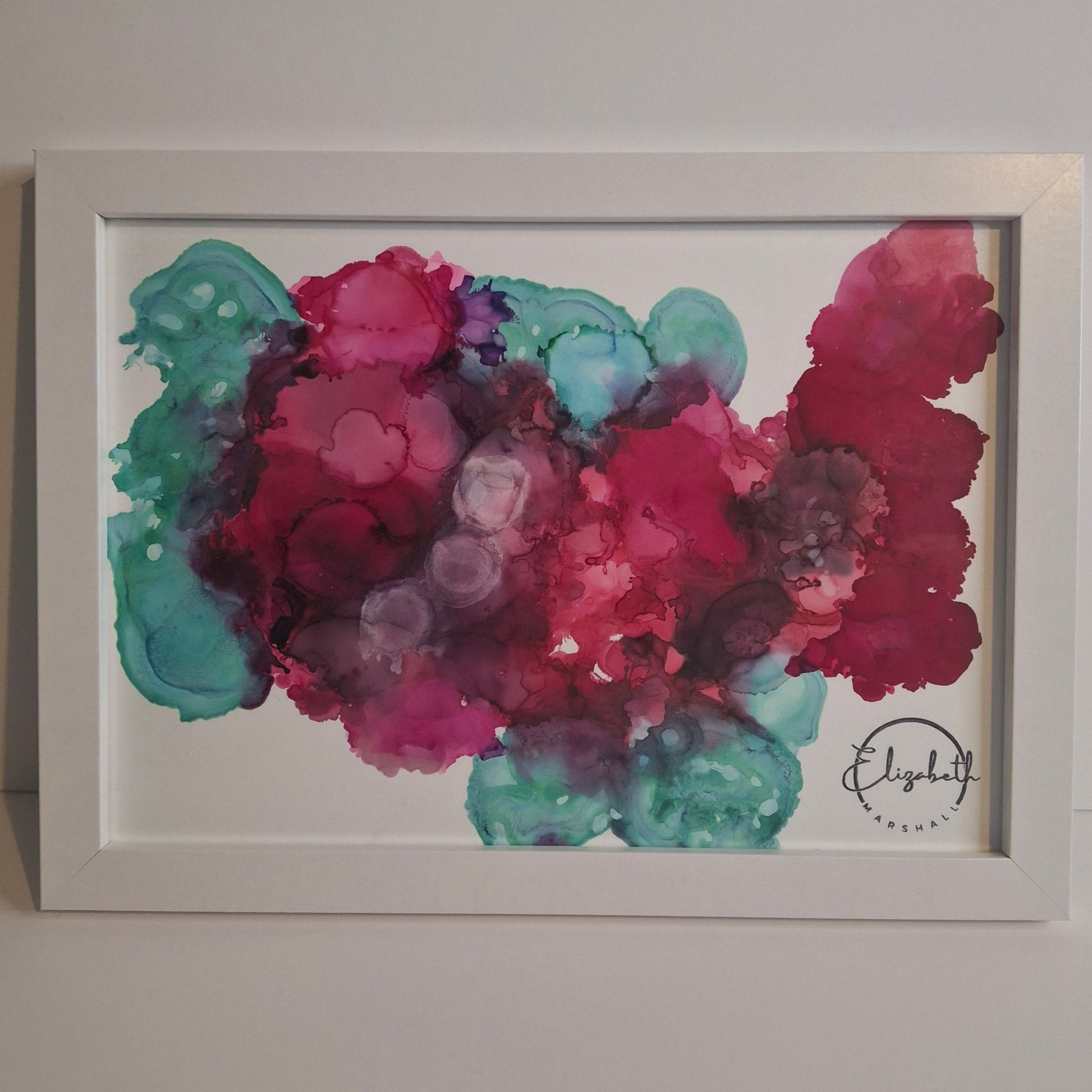 Framed abstract alcohol ink painting in rich crimson, plum, and teal titled Currents of the Heart by Elizabeth Marshall.