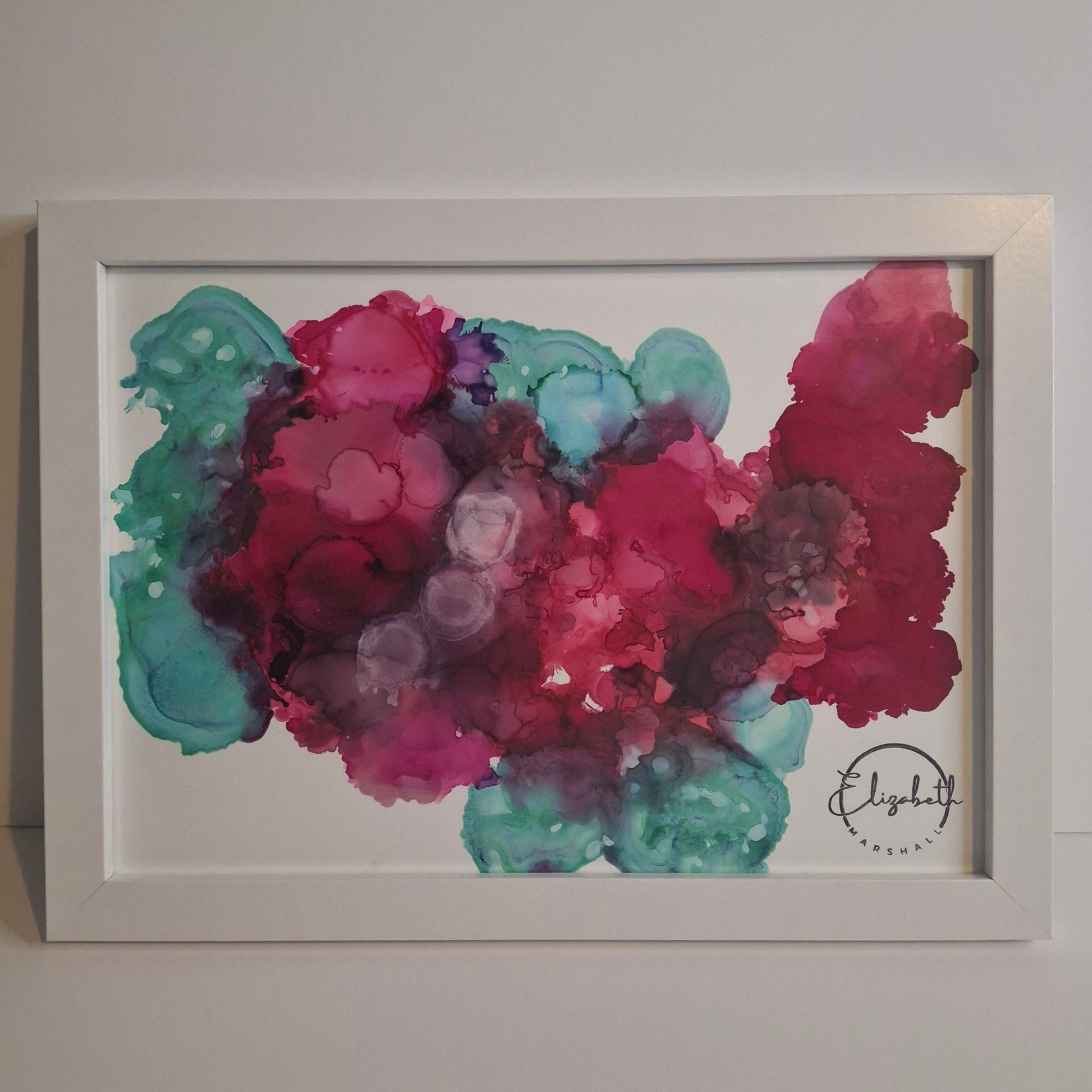 Framed abstract alcohol ink painting in rich crimson, plum, and teal titled Currents of the Heart by Elizabeth Marshall.