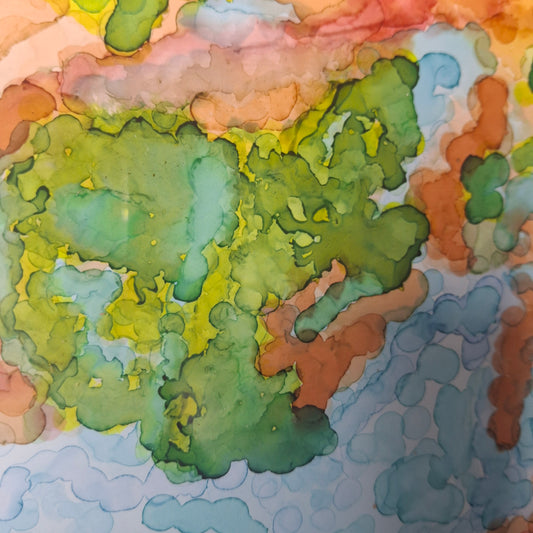 Close-up of Reef Dreaming alcohol ink artwork, showing layered blue currents flowing into coral reef-like shapes in warm and cool colours.