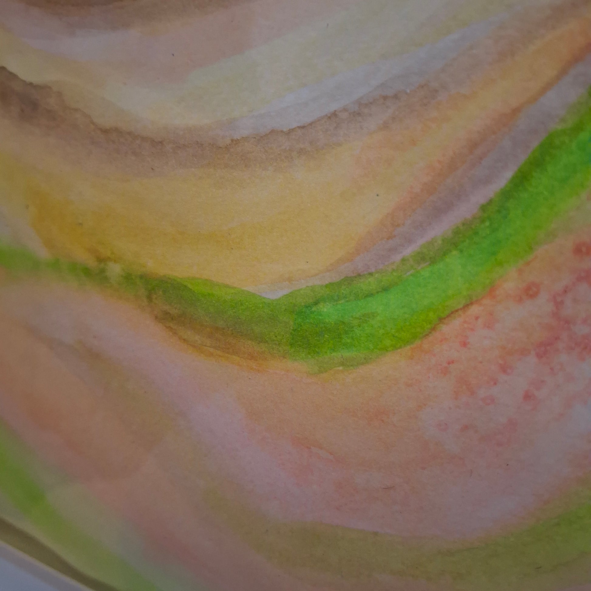 Close-up of a watercolor painting with soft, blended colors.