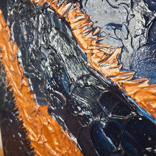 Close-up of a textured surface with black and copper colors